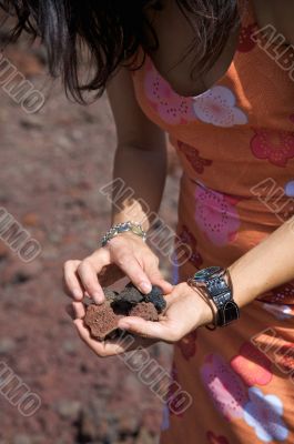 volcanic stones on her hands