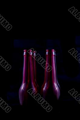 red beer bottles isolated on a black background