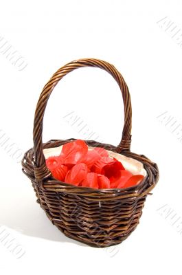 wicker basket filled with red rose peddles