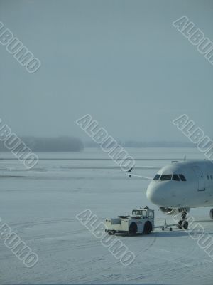 a towed airplane in the white snow