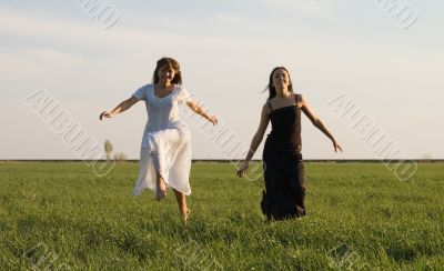 Two girls running on the field