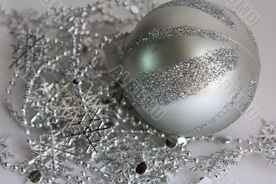 The striped sphere lays on brilliant snowflakes