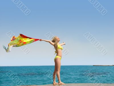 Girl with scarf on a sea beach