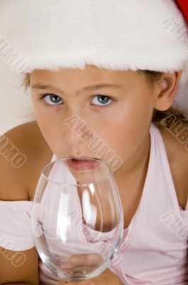 little girl with christmas hat and wine glass