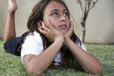 little boy lying on grass and looking aside
