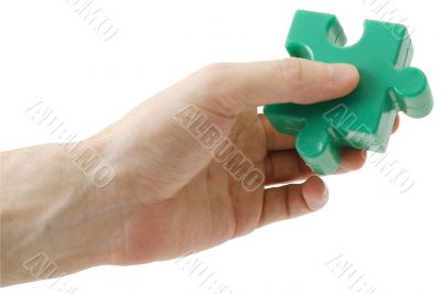 Puzzle piece in hand