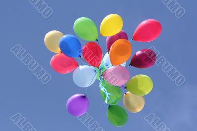 Multi colored balloons in blue sky