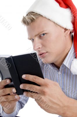 man holding book and looking askance