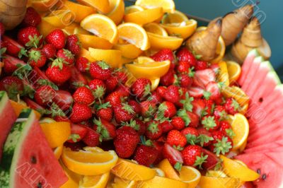 Dish with strawberry, oranges and watermelon