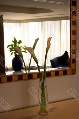 Greater floor vase with a flower in a lobby