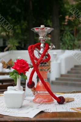Hookah and red rose in vase