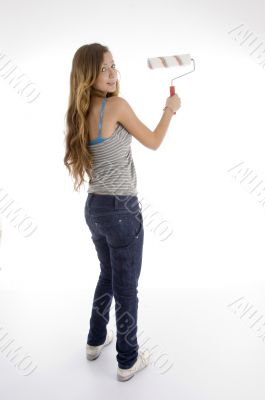 young female painter with roller brush