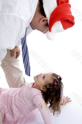 father wearing christmas hat  with his daughter