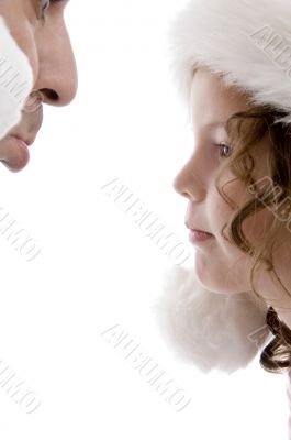 close up of father and girl wearing christmas hat