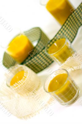 five yellow candles and ribbon