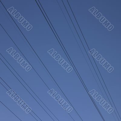 black electric wires in the blue sky