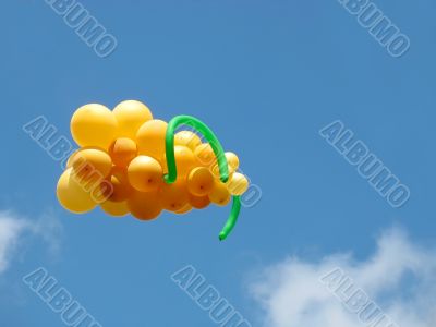 Sheaf of balloons in the form of grapes cluster against the blue sky
