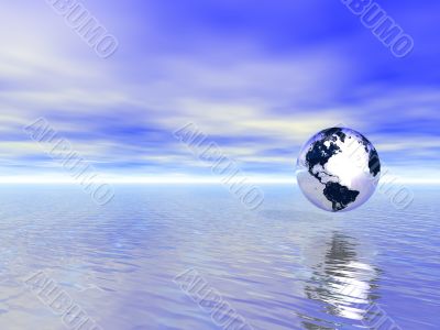 abstract glass globe over blue ocean and sunset