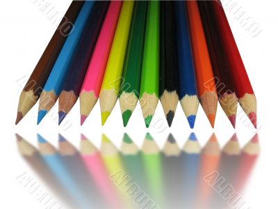 Color pencils with mirror reflection isolated over white background