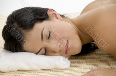 young woman sleeping on mat