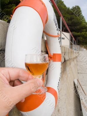 Wine-glass with a wine and a lifebuoy ring
