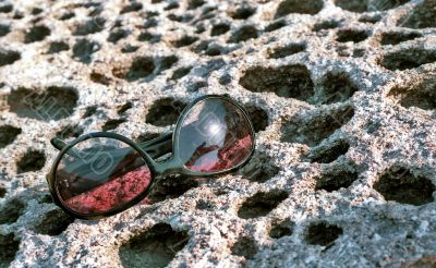 Sun glasses on honeycomb stone