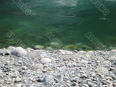 grey rock and green river