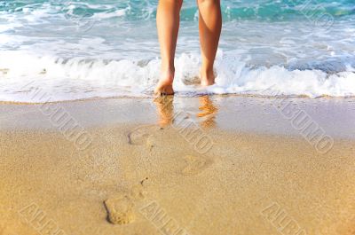 Woman`s legs, going to sea