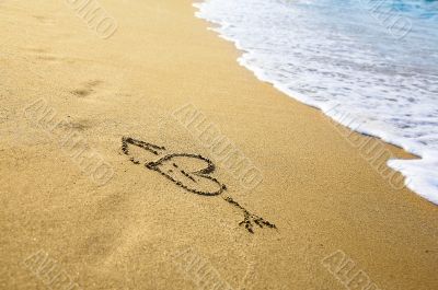 `Heart` drawing at sand, with sea wave