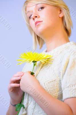 Blond Woman with a Bright Yellow Flower