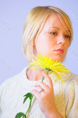 Blond Woman with a Bright Yellow Flower