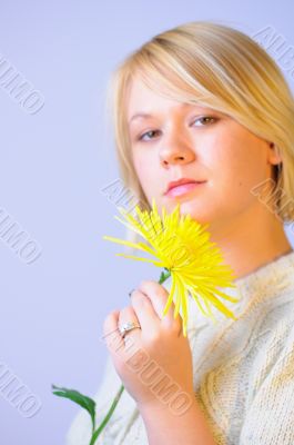 Blond Woman with a Bright Yellow Flower