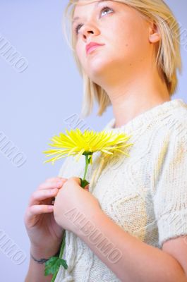 Blond Woman with a Bright Yellow Flower