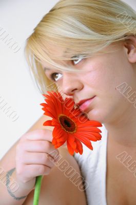 Blond Woman with a Bright Orange Flower