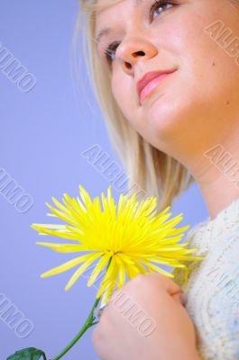 Blond Woman with a Bright Yellow Flower