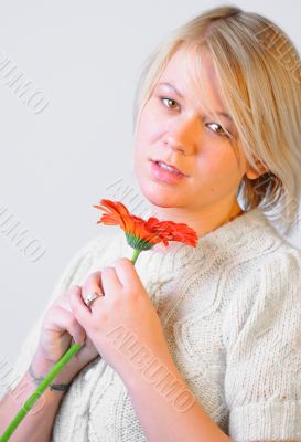 Blond Woman with a Bright Orange Flower