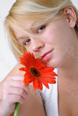 Blond woman with an Orange Flower