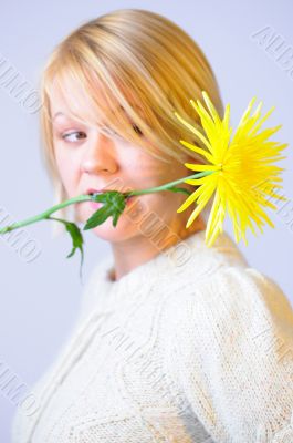 Blond Woman with a Bright Yellow Flower