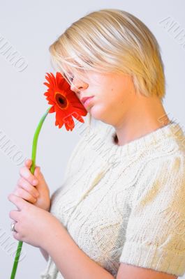 Blond woman with an Orange Flower