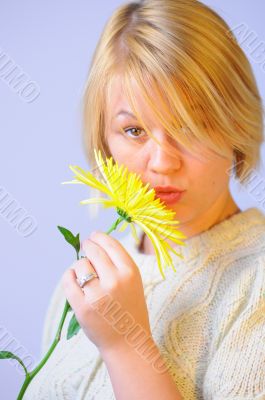 Blond Woman with a Bright Yellow Flower