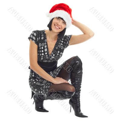 Christmas time. Young woman wearing Santa hat.