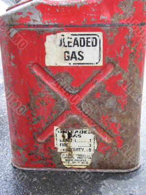 an old and rusty red gas can