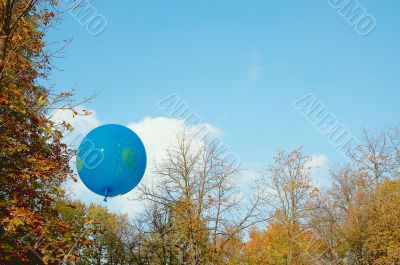 Blue ballon in the autumn sky.