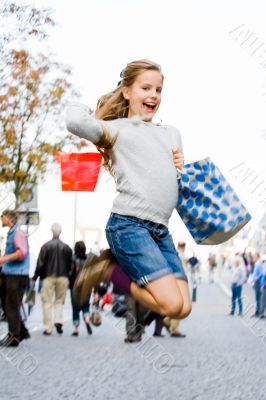 Young girl is jumping on the streets