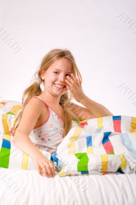 Rub her eyes cleam from sleep