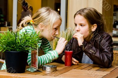 2 girls drinking some juice