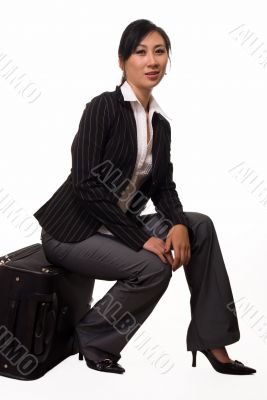 Woman sitting on luggage