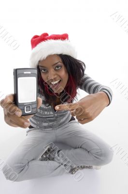 sitting girl indicating cell phone