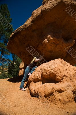Woman posing under rock