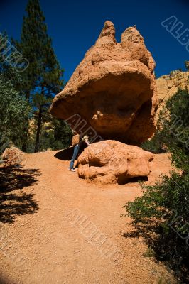Woman posing under rock